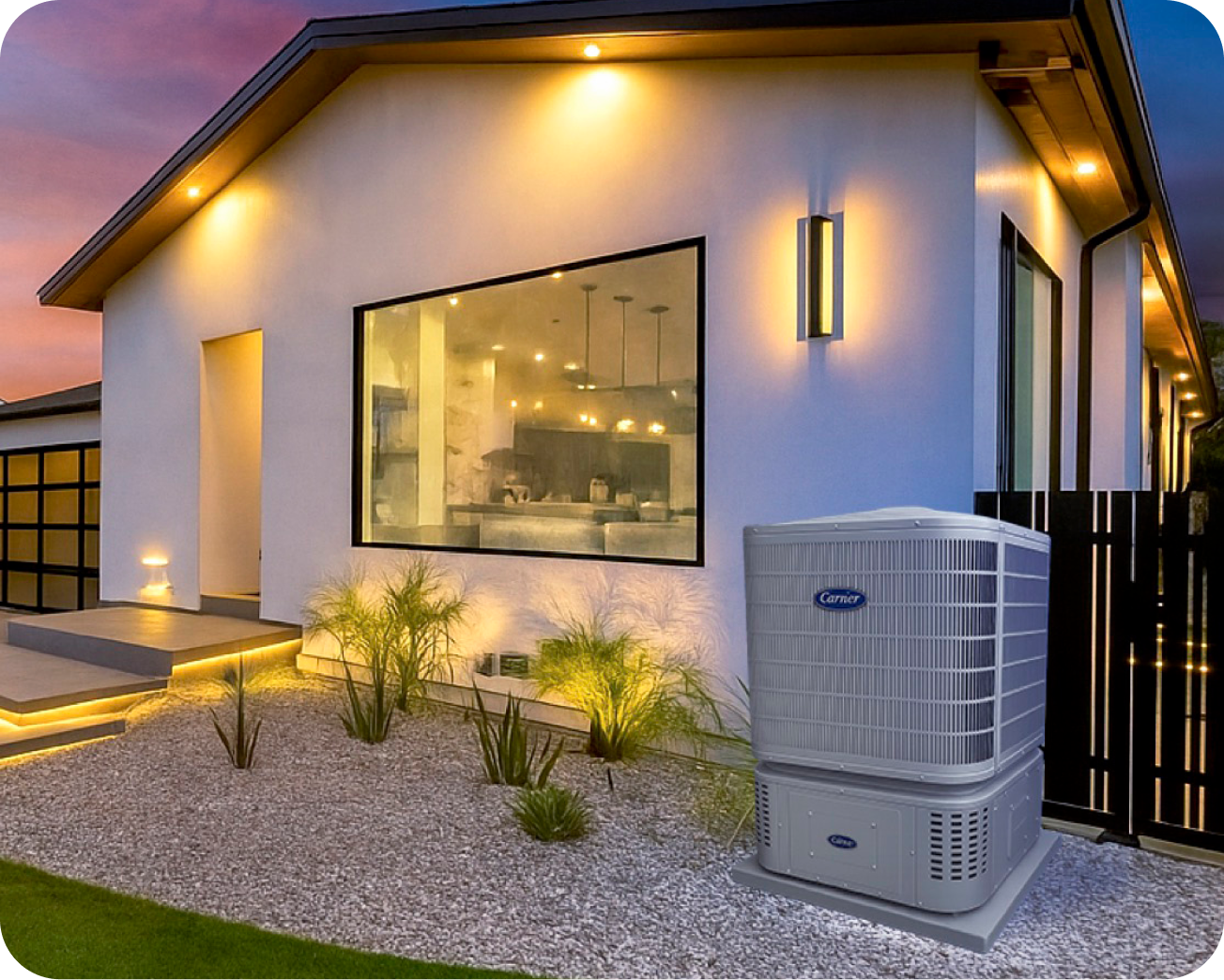 Exterior of home warmly lit in evening with HVAC heat pump with connected energy system
